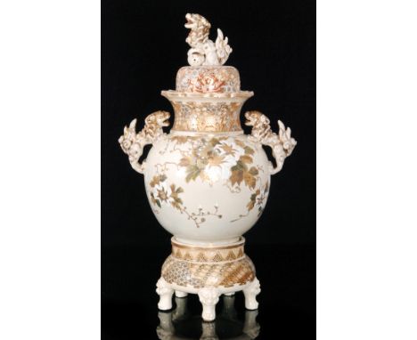A late 19th Century Satsuma vase, cover and stand, the vase of ovoid form with a flared collar neck decorated with enamel and