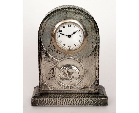 An early 20th Century mantel clock in the Arts and Crafts style, the front decorated with a deer shot by an arrow, the wooden