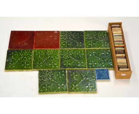 A set of eight 6" Lewis F. Day for Pilkington's dust pressed tiles decorated with a foliate motif and three flower heads, all