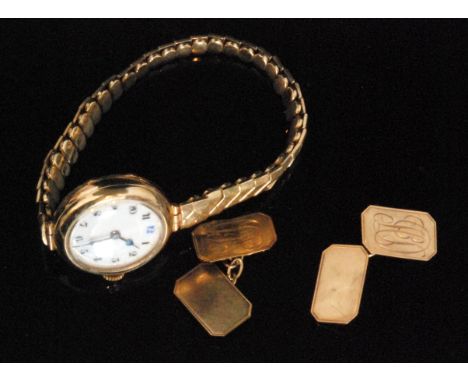 An early 20th Century 9ct ladies wrist watch with circular white enamel dial to expandable gold plated bracelet, London 1929,