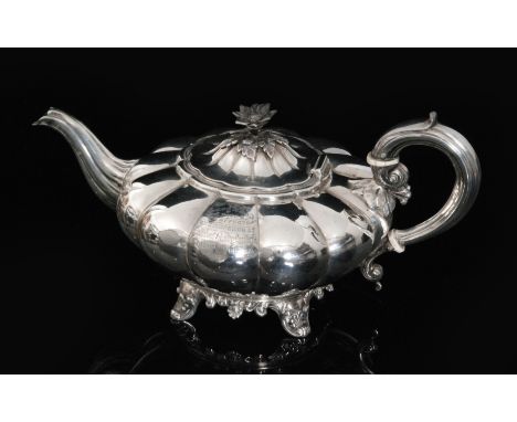 A William IV hallmarked silver melon shaped teapot with plain lobed body below hinged lid with flower finial, scroll handle a