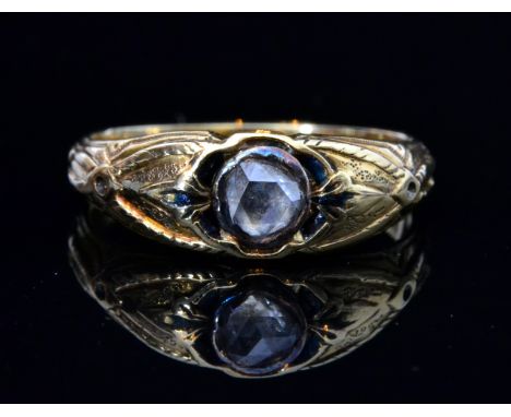 A yellow metal single stone diamond ring, rose cut diamond collar set within blue enamel highlighted and engraved head, shank