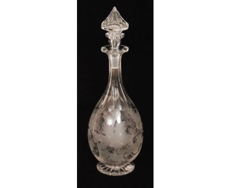 A late 19th Century Stourbridge clear crystal glass decanter of footed ovoid form with a slice cut neck and ornate hollow blo