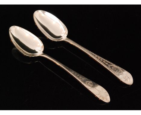 A composed pair of George III Irish silver tablespoons, Old English pattern, each with bright cut engraved decoration, the fi