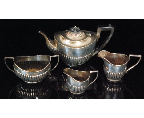 An Edwardian hallmarked silver four piece tea service comprising of tea pot, twin handled sugar bowl, milk and cream jug, eac