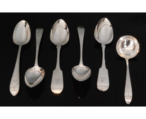 A pair of Irish hallmarked silver fiddle pattern table spoons with engraved crest to terminals, together with three further s