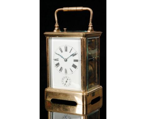 A late 19th Century French brass carriage clock with push button repeat striking on a gong, white enamelled dial encorporatin