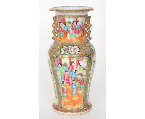 A late 19th to early 20th Century Chinese Canton enamel famille rose vase decorated with cartouche panels of ladies in conver