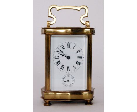 A 20th Century French brass carriage clock in a shaped cartouche case with a white enamelled dial and subsidiary dial strikin