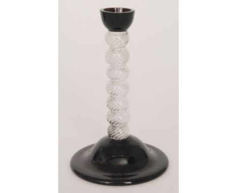 A 1930s glass candlestick with a small purple scone raised to a clear crystal glass bobbin stem with internal multiseries air