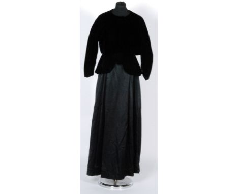 A 1950s Christian Dior, Paris, black velvet short evening jacket with collarless round neck, two button fastenings, two shall