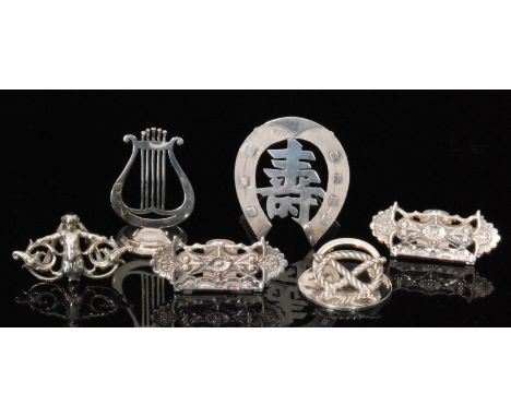 Three hallmarked silver menu holders; a Staffordshire knot, a harp and a cherub, together with three further unmarked menu ho
