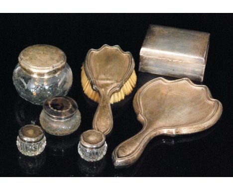 An Art Nouveau Sterling silver four piece dressing table set comprising of a hand mirror, hand brush and two covered jars, th