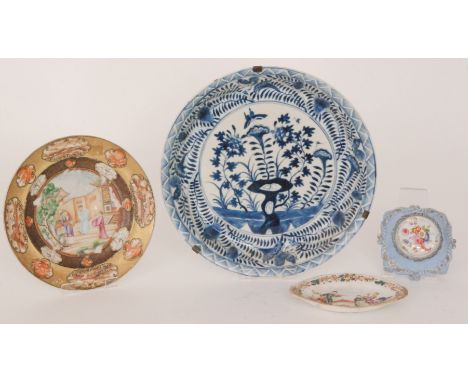 A 19th Century Chinese cabinet plate, the central reserve decorated with figures set within a walled garden, framed with two 