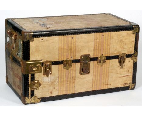 An 1930s  travelling wardrobe or steamer trunk, with applied red letters 'Alicia Markova Theatre', the tan coloured linen cla