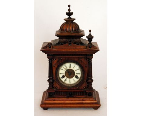 A Victorian carved walnut cased mantle clock with eight day striking movement titled the The Greenwich Clock, turned finials 