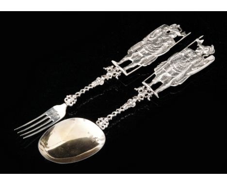 A 19th Century Dutch silver ornate spoon and fork each with figural terminals and hanging rings above pierced stems, length 3