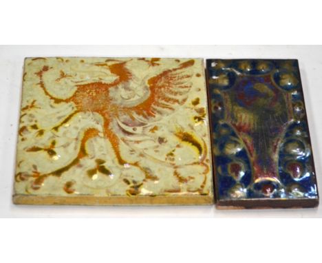 A 3" x 6" Pilkington's framed plastic clay lustre tile decorated to a design by Gordon Forsyth with a gold lustre heraldic ea