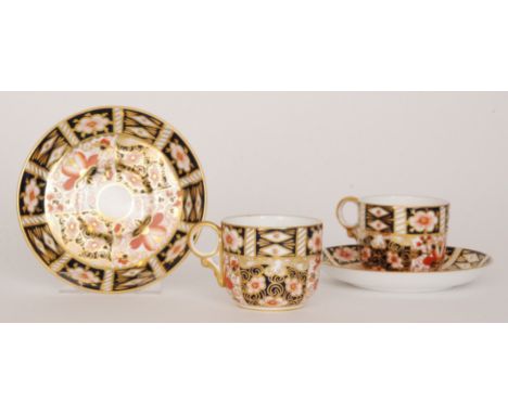 Six Royal Crown Derby coffee cups and saucers decorated in the traditional Imari pattern 2451, printed marks with date cipher
