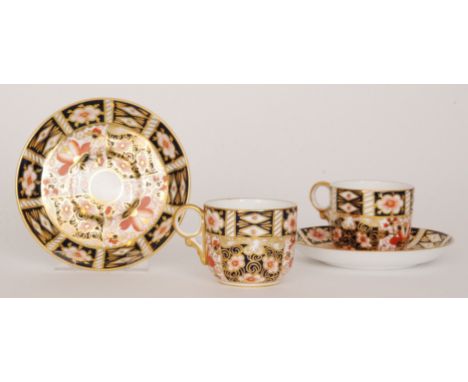 Six Royal Crown Derby coffee cups and saucers decorated in the traditional Imari pattern 2451, printed marks with date cipher