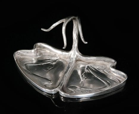 An Art Nouveau hallmarked silver ring tree, the base embossed with two maidens heads, their flowing hair forming a raised whi