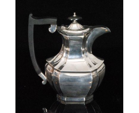 A hallmarked silver coffee pot of plain form, part faceted body terminating in ebonised scroll handle and oval finial, height