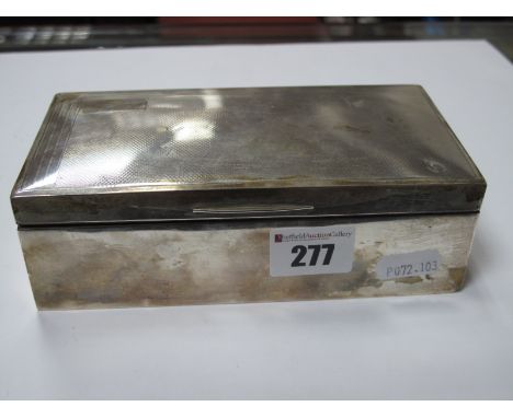 A Hallmarked Silver Cigarette Box, JR, Birmingham 1977, of plain rectangular form with engine turned lid, 16.5cm wide.