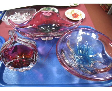 A Murano Type Ruby Tinted Freeform Bowl, on clear quatrefoil foot, a ruby tinted basket and circular bowl.