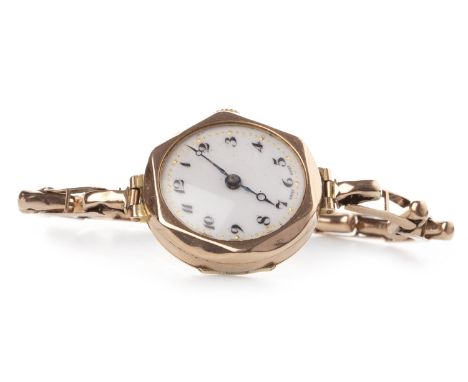 LADY'S EARLY TWENTIETH CENTURY NINE CARAT GOLD MANUAL WIND WRIST WATCH, the round white enamel dial with Arabic numerals in b