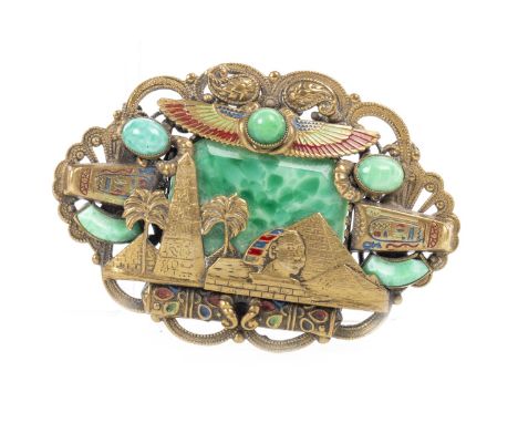 GILT METAL, JADEITE GLASS AND ENAMEL BROOCH, most probably by Max Neiger of Gablonz, decorated with pyramids, sphinx, palm tr