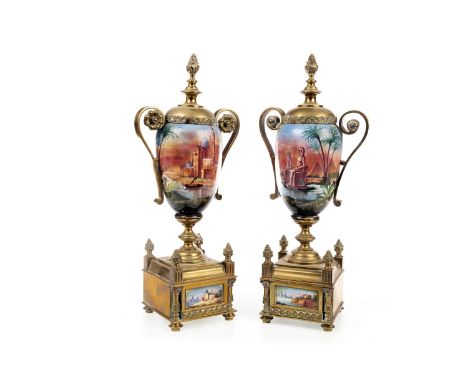 PAIR OF BRASS AND CERAMIC GARNITURE VASES, decorated with pyramids and a desert town, on square bases, inset ceramic panels, 