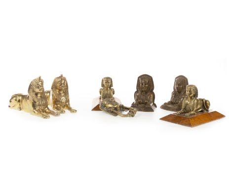 PAIR OF BRASS SPHINX DESK WEIGHTS, mounted on an oak panel, 22 cm long; along with a pair of brass sphinxes, a pair of brass 