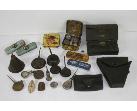 Assorted bicycle spares and accessories,including oil cans, tool pouches, puncture repair kits, a large frame vice, a home-ma