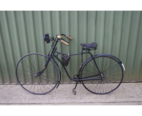 A Gent's safety bicycle, circa 1890,black painted framework, top bar fitted with leather tool bag, repaired leather saddle on