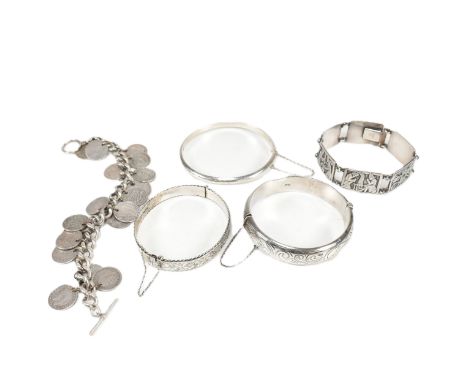 Five silver bangles and bracelets. Lot to include a hallmarked silver engraved hinged bangle, hallmarked for Birmingham 1961.