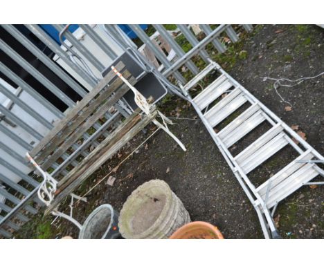 A CAST IRON AND WOODEN SLATTED GARDEN BENCH, with distressed slats, width 122cm, along with two step ladders (3)