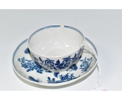AN EIGHTEENTH CENTURY ROYAL WORCESTER TEA BOWL AND SAUCER with a blue and white floral pattern with butterflies, a small flow