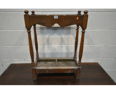 A 20TH CENTURY OAK STICK / UMBRELLA STAND, with three divisions, and a metal drip tray, width 56cm x depth 27cm x height 77cm