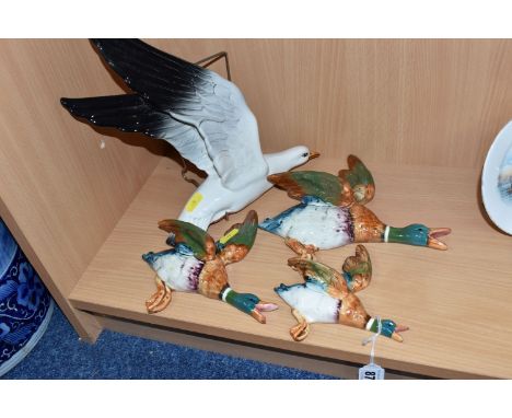 A GROUP OF FOUR BESWICK BIRD WALL PLAQUES comprising a trio of three mallards to include 562-2, 562-3, 562-4 (some light craz