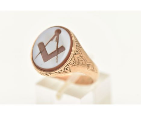 A GENTS 9CT GOLD, MASONIC SIGNET RING, of an oval form, set with a carved sardonyx inlay depicting the Masonic compass and sq