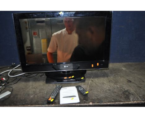 A LG 32LH5000 32in TV WITH REMOTE along with a Philips DVD player with remote and manual (5)