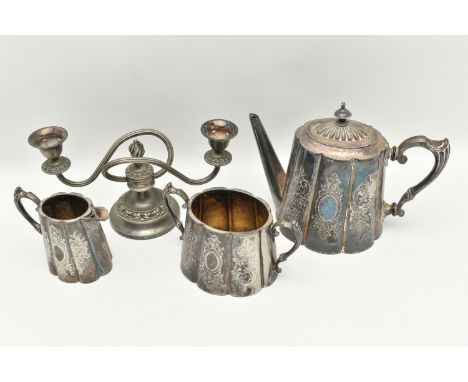AN ASSORTMENT OF WHITE METAL, to include a three piece tea set with floral detail, together with a two branch candelabra, (co
