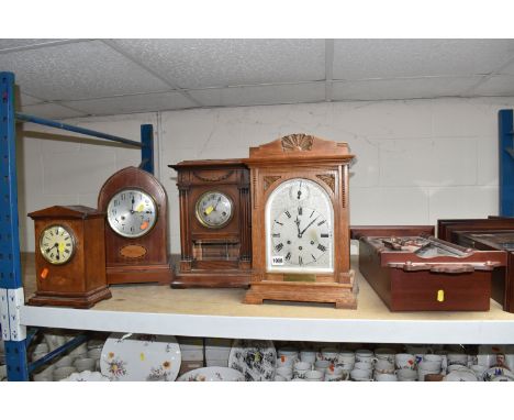 SIX WOODEN CASED CLOCKS, comprising two reproduction mahogany style wall clocks, an early 20th century light oak cased Westmi