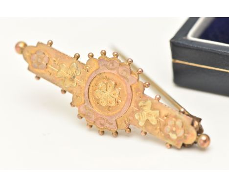 A YELLOW METAL SWEETHEART BROOCH, floral pattern with applied bead work surround, fitted with a base metal brooch pin with C 