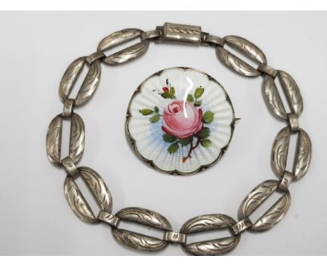 A NORWEGIAN SILVER AND ENAMEL ROSE PATTERN BROOCH AND A SILVER BRACELET 15.4G GROSS