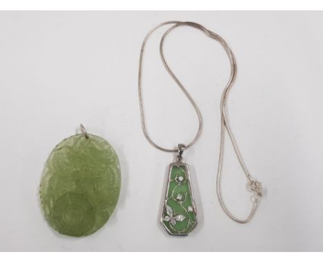 A CARVED JADE PENDANT DEPICTING A DRAGON TOGETHER WITH A JADE WHITE STONE AND SILVER PENDANT ON SILVER CHAIN