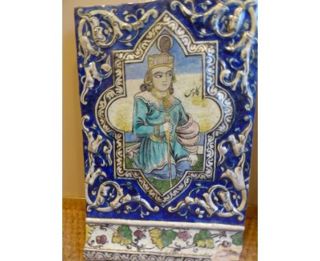 A collection of four C19th Persian Qajar tiles depicting noblemen and a country scene. The cobalt blue borders with scrolling