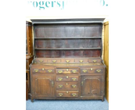 LATE 18TH CENTURY CONWY VALLEY OAK DRESSER, the shaped rack with wide back boards and five lower spice drawers over a fully o