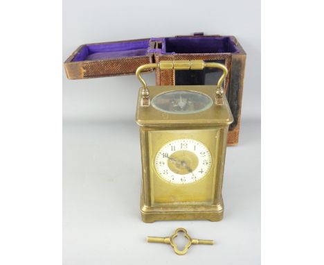 VINTAGE BRASS CASED CARRIAGE CLOCK with white enamel dial set with roman numerals with winding key, in original travel case, 