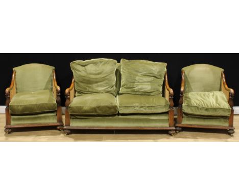 An early 20th century oak three-piece bergère drawing room suite, comprising a sofa and a pair of armchairs, the sofa 92cm hi